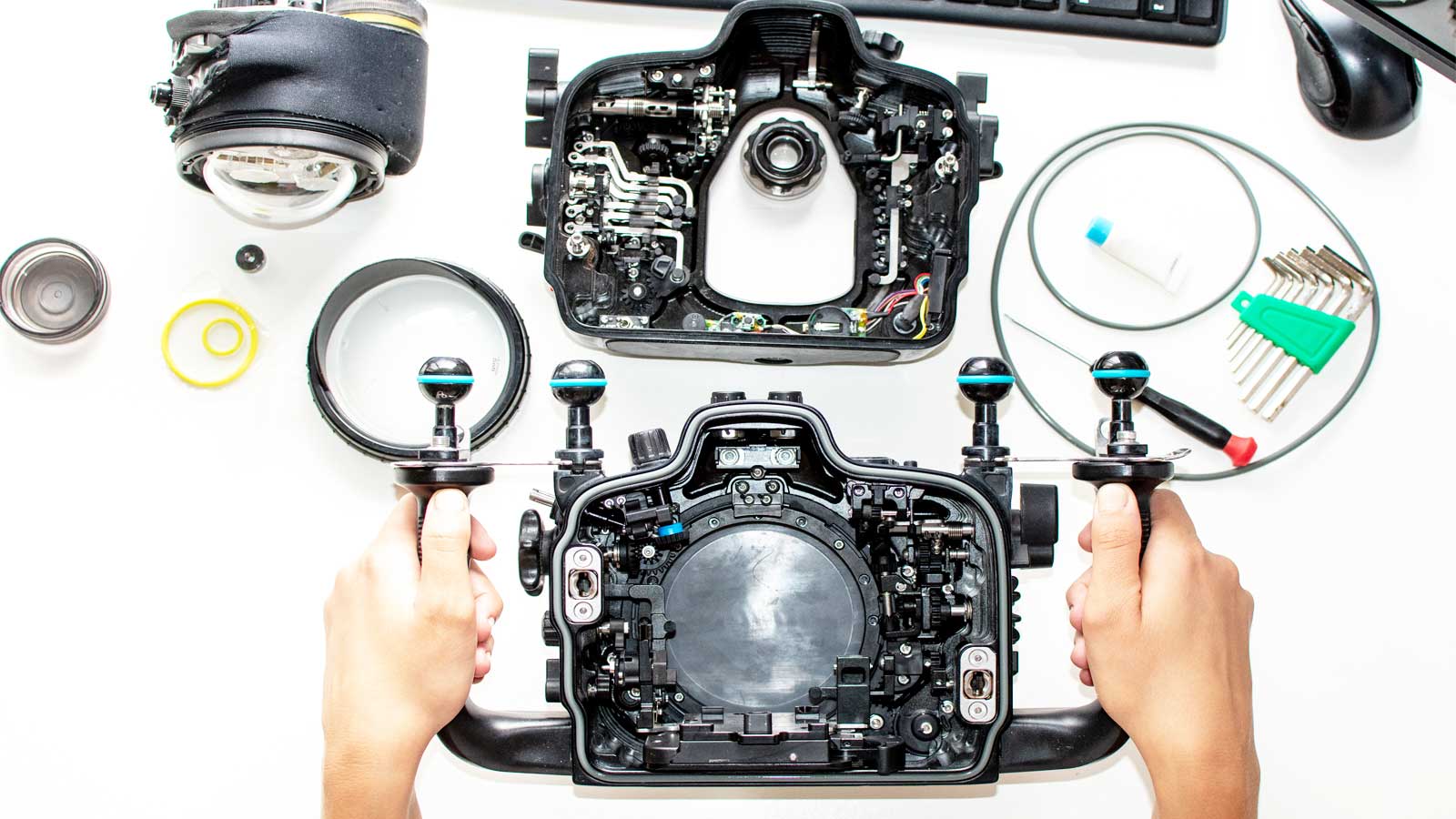 A student carefully assembles an underwater housing in preparation for a dive, showcasing the attention to detail in underwater photography.